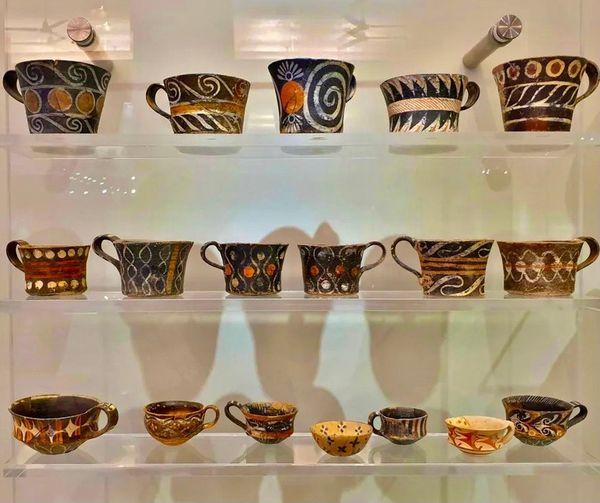 This is a very visual post. Rows of mugs with swirled patterns counterpointed with wave motifs. Darker colours mixed in with vibrant ochres and clean whites in rhythmic bands around each piece.